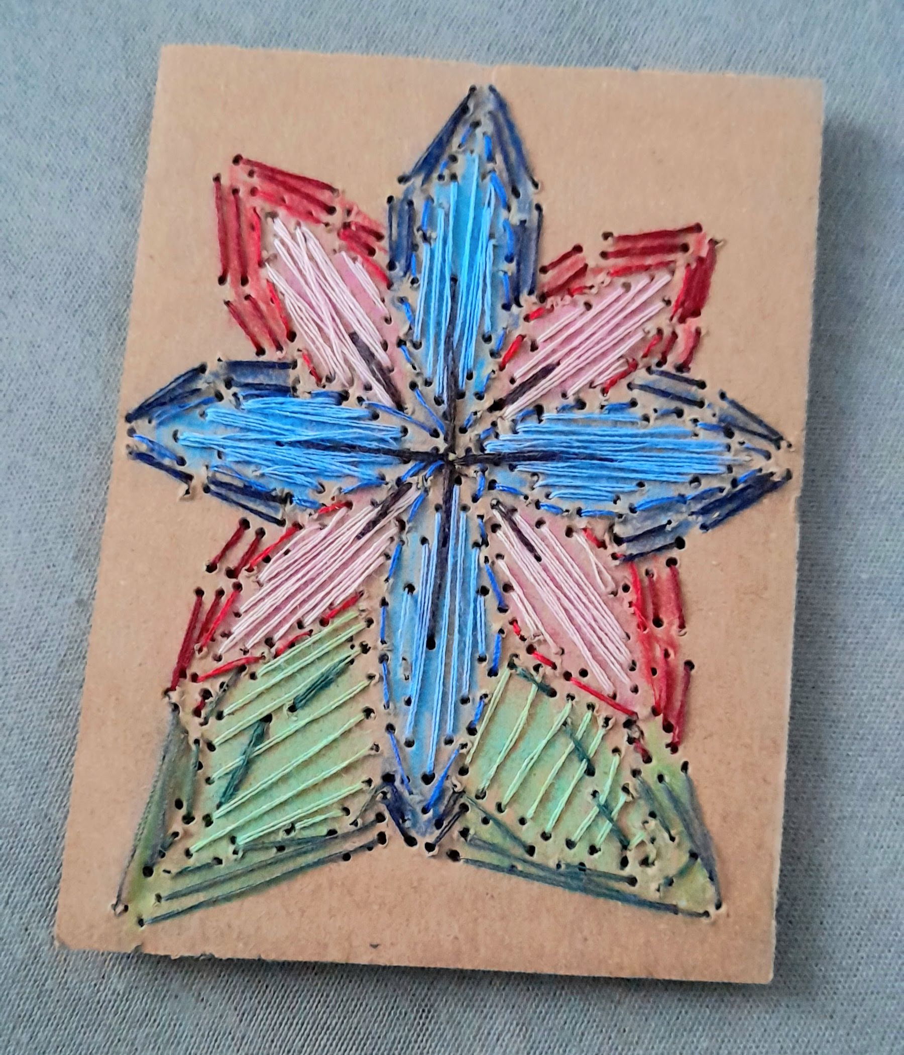 flower embroidered on a piece of cardboard