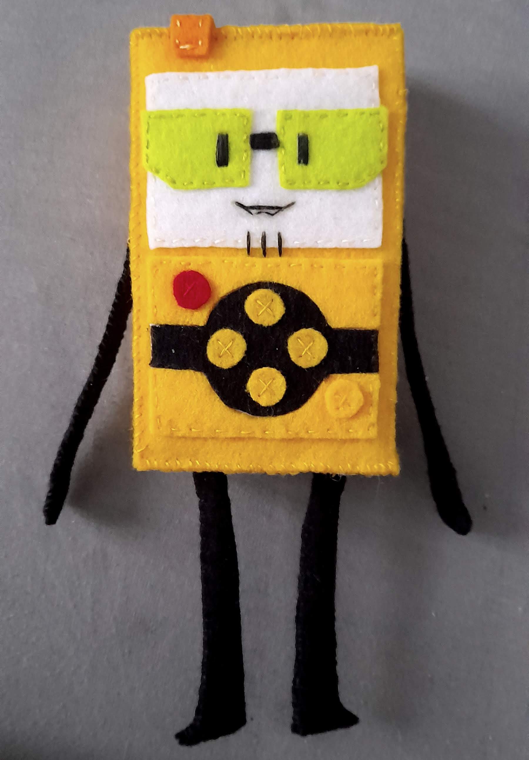 a plushie of cracklin, a yellow geiger counter with green glasses